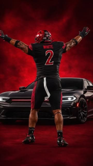 Texas Tech athlete White, number 2, in front of a detailed black Camaro